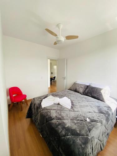 a bedroom with a bed and a ceiling fan at Apartamento Mobiliado em Extrema MG in Extrema