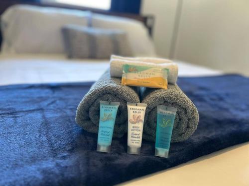 a group of four facial care products on a towel at Beautiful home in West Palm - 5 min to Airport in West Palm Beach