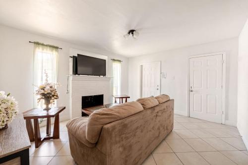 a living room with a couch and a fireplace at Beautiful home in West Palm - 5 min to Airport in West Palm Beach