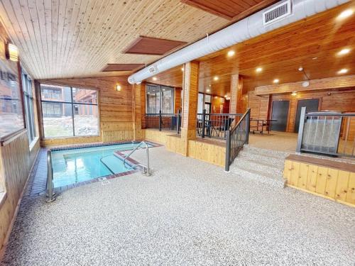 a swimming pool in the middle of a house at Moose Mtn Retreat Ski in out Condo Pool Hot Tub Fire Pits in Lutsen