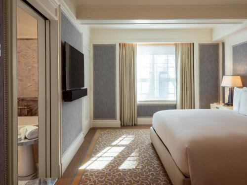 a hotel room with a bed and a window at The Surrey, A Corinthia Hotel in New York
