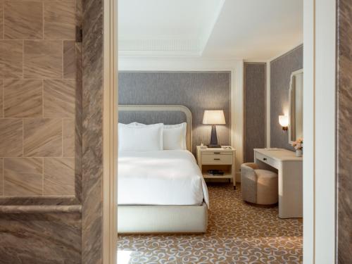 a hotel room with a bed and a bathroom at The Surrey, A Corinthia Hotel in New York