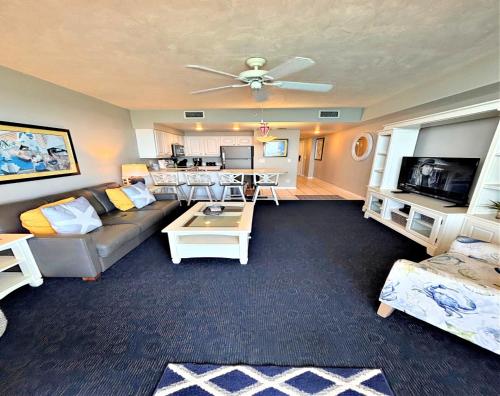 a living room with a couch and a table at 16th Floor 1 BR Resort Condo Direct Oceanfront Wyndham Ocean Walk Resort Daytona Beach 1605 in Daytona Beach