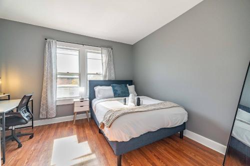 a bedroom with a bed and a desk and a window at Cozy Brick-Short North Condo - (fenced yard) - OSU in Milo