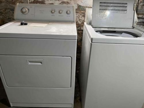 a white stove top oven next to a white refrigerator at Cozy Brick-Short North Condo - (fenced yard) - OSU in Milo