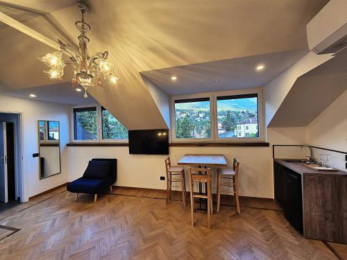 a kitchen and dining room with a table and chairs at Residenza Laurum in Mandello del Lario