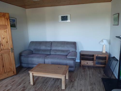 a living room with a couch and a coffee table at Teach Chnoc na hEorna in Goleen