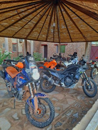a group of motorcycles parked under a tent at Riad IZRAREN in FIGUIG in Zenaga