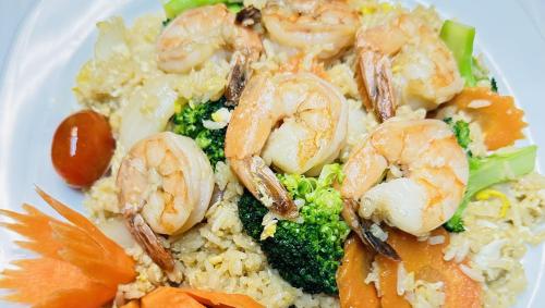 a plate of shrimp and broccoli and rice at Colonial Inn Ellsworth in Ellsworth