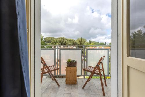 a balcony with two chairs and a plant on it at Lido Beach Escape with Balcony x5! in Lido di Pomposa