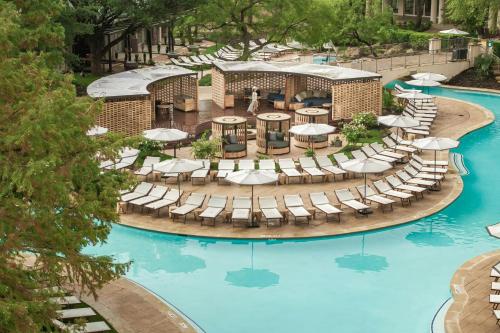 an overhead view of a pool with chairs and umbrellas at The Ritz-Carlton Dallas, Las Colinas in Irving