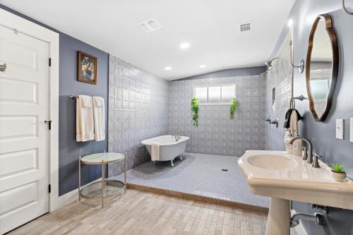 a bathroom with a tub and a sink and a toilet at Suite C Beach, Firepit, Dog-friendly, Downtown! in Biloxi