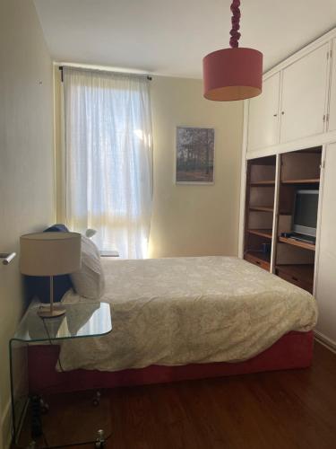 a bedroom with a bed and a table with a lamp at ROOM in Molhe house with pool in Porto