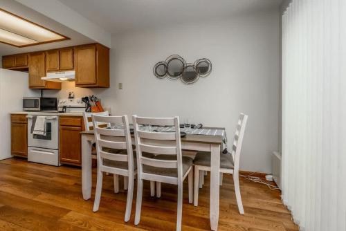 a kitchen with a table and chairs in a room at Family Friendly and quite 2 bedroom Condo Close to Fun in Fort Wayne
