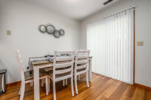 a dining room with a table and chairs and a window at Family Friendly and quite 2 bedroom Condo Close to Fun in Fort Wayne