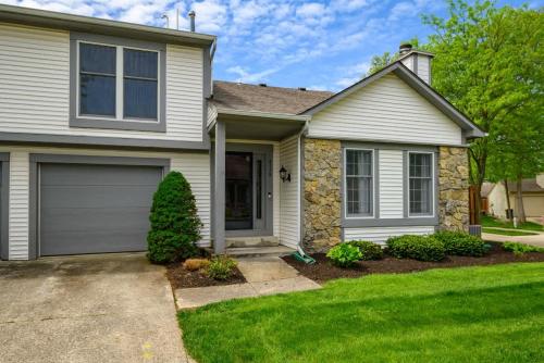 a house with a garage and green grass at Family Friendly and quite 2 bedroom Condo Close to Fun in Fort Wayne