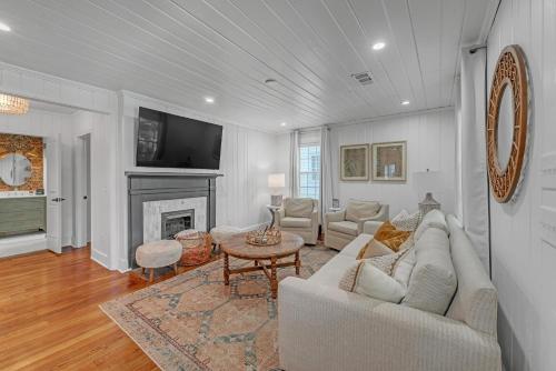 a living room with a couch and a fireplace at Bungalow off Floyd St in the heart of Covington bungalow in Covington