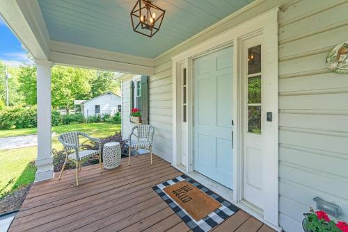 a porch with chairs and a door on a house at Bungalow off Floyd St in the heart of Covington bungalow in Covington