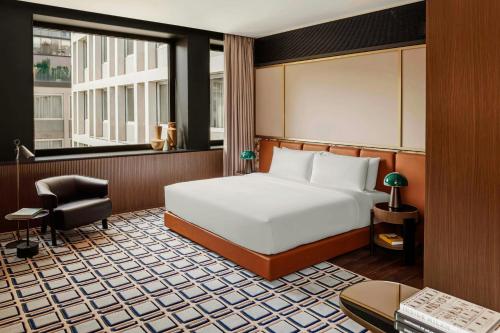 a bedroom with a bed and a desk and a chair at Casa Brera, a Luxury Collection Hotel, Milan in Milan