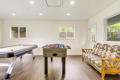 a living room with a pool table and a couch at Deck, Yard and Game Room Fun-Filled Redmond Home in Redmond