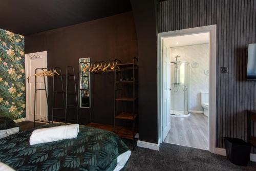a bedroom with a bed and a bathroom with a shower at Large House for Groups with Huge Driveway - FREE PARKING in Middlesbrough