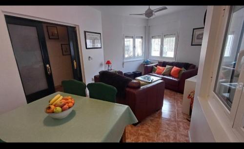 a living room with a bowl of fruit on a table at Calle Dr Fleming 3 bedroom home for 6 people in San Javier