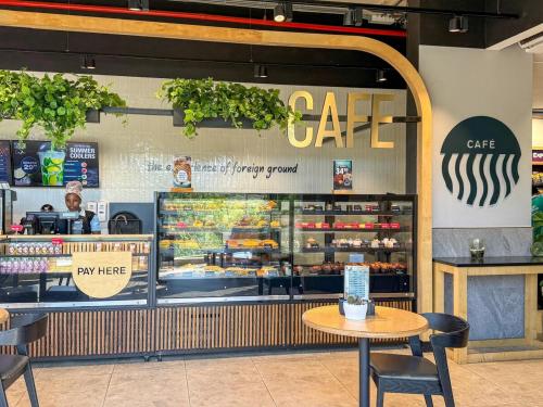 a cafe with a table in front of a window at Luxury 2Bedroom Apart with Ocean & Forest Views in Umhlanga