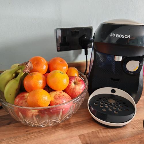 a mixer and a bowl of fruit on a table at Ocean City Apartment-with parking in Plymouth