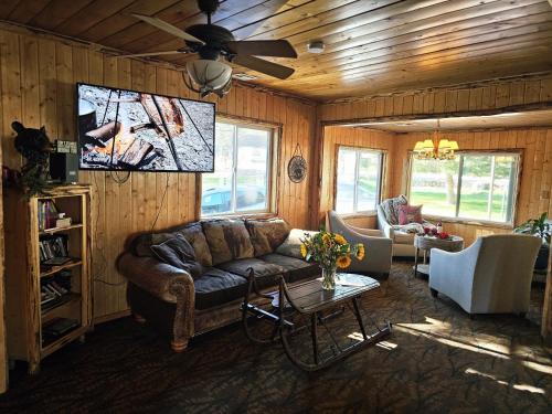 a living room with a couch and a flat screen tv at Big Bear Frontier in Big Bear Lake