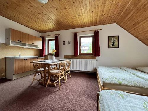 a bedroom with a table and a bed and a kitchen at U Javoru in Albrechtice v Jizerských horách