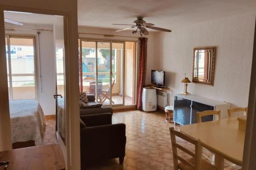 un salon avec un canapé, une table et une télévision dans l'établissement Apartment in the port of Hyères, à Hyères