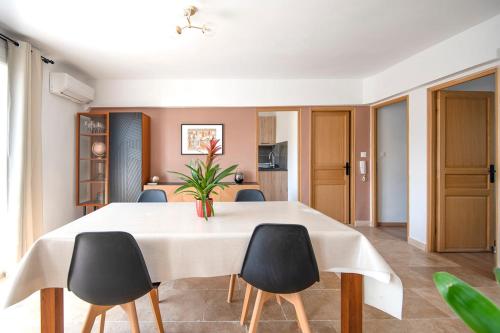 une salle à manger avec une table et des chaises blanches dans l'établissement Beautiful apartment of 65 m2 in the 8th Marseille, à Marseille