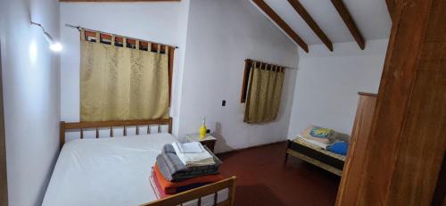 a small room with two beds and a window at casa acogedora in Melipeuco