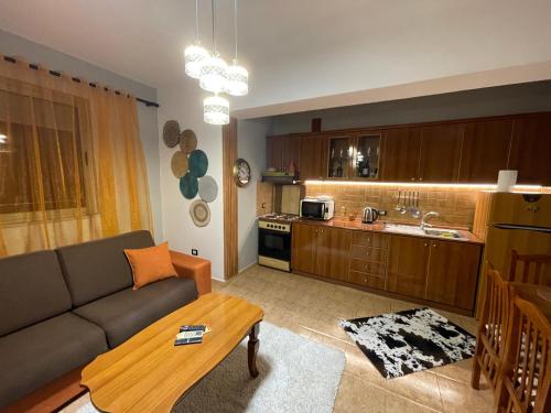 a living room with a couch and a kitchen at Temali Apartment 3 in Shkodër