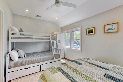 a bedroom with two bunk beds and a window at Thayer Beach Lakehouse in Colchester