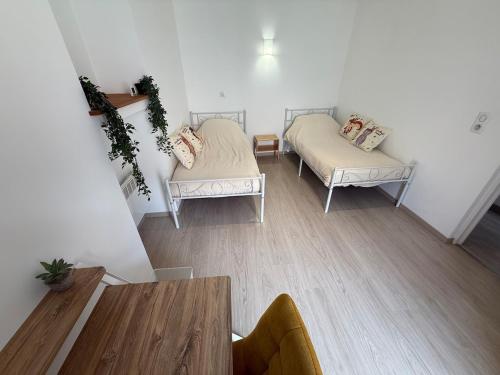 a small room with two beds and a table at Beautiful apartment in Tende Vallée des Merveilles in Tende