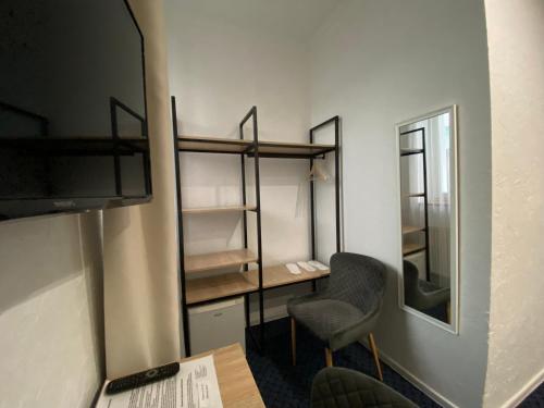 a room with a desk and a chair and a mirror at Staryi Krakiv in Lviv