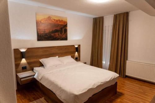 a bedroom with a large bed in a room at Bici Resort in Samoljica