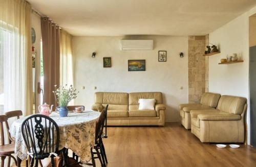 a living room with a table and a couch at RomaOlyaHouse in Budva