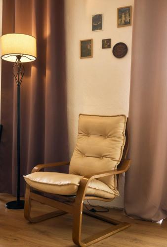 a chair and a lamp in a room at RomaOlyaHouse in Budva
