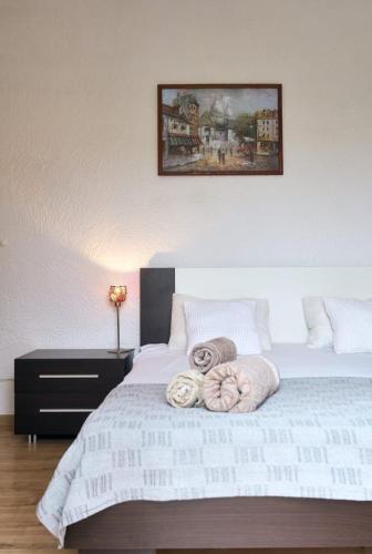 a bedroom with a bed with two towels on it at RomaOlyaHouse in Budva