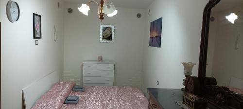 a bedroom with a bed and a dresser and a mirror at Casa Nonna Trentina in Melfi