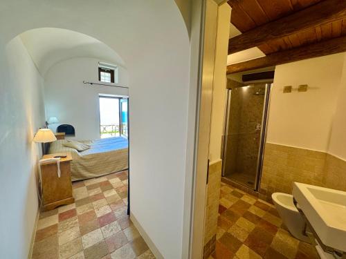 a bathroom with a sink and a bed in a room at Villa Il Frantoio and Lilmar in Praiano
