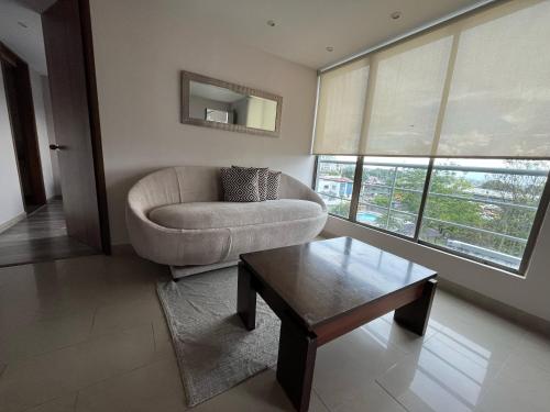 a living room with a couch and a coffee table at Santorini Apartamentos Amoblados in Pereira