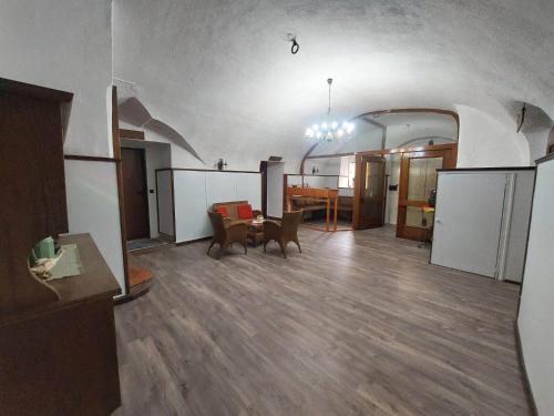 a living room with a table and a dining room at Hotel&Restaurant Gasthof zur Post Eisenerz in Eisenerz