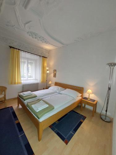 a bedroom with a large bed and a ceiling at Hotel&Restaurant Gasthof zur Post Eisenerz in Eisenerz