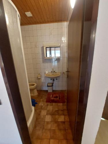 a small bathroom with a sink and a toilet at Hotel&Restaurant Gasthof zur Post Eisenerz in Eisenerz