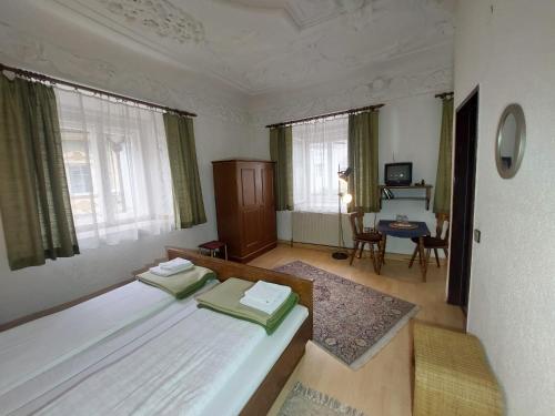 a bedroom with a bed and a table and chairs at Hotel&Restaurant Gasthof zur Post Eisenerz in Eisenerz