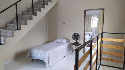 a bedroom with a bed and a staircase at Casa Gaita Triunfo in Triunfo