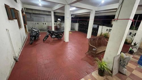 two motorcycles parked in a room with red tile floors at VL Vididhillu FF1 in Vizianagram City